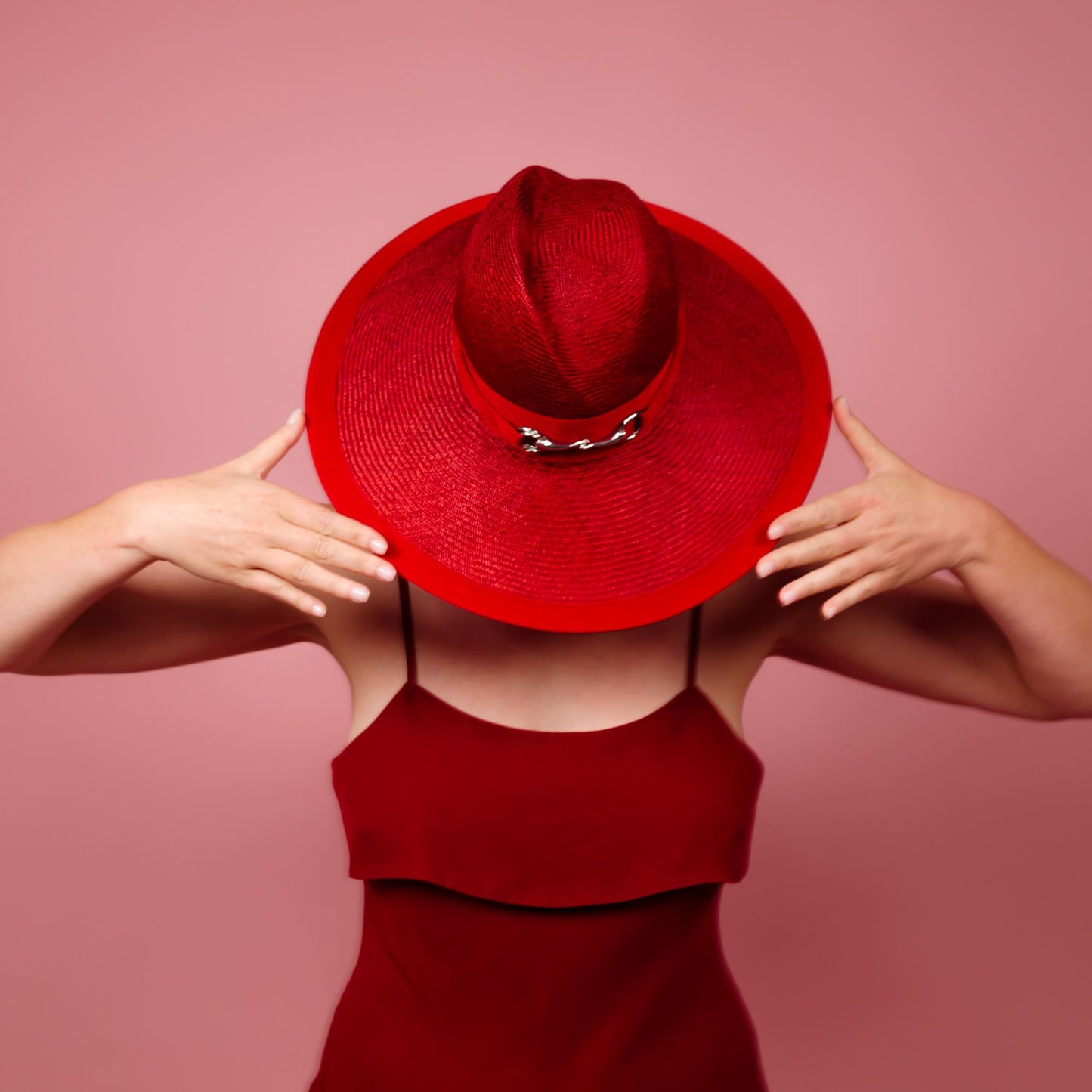 Charlotte wide brimmed hat with shaped crown in red straw and silver buckle