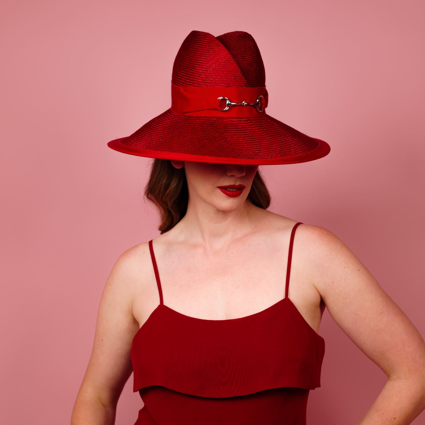 Charlotte wide brimmed hat with shaped crown in red straw and silver buckle