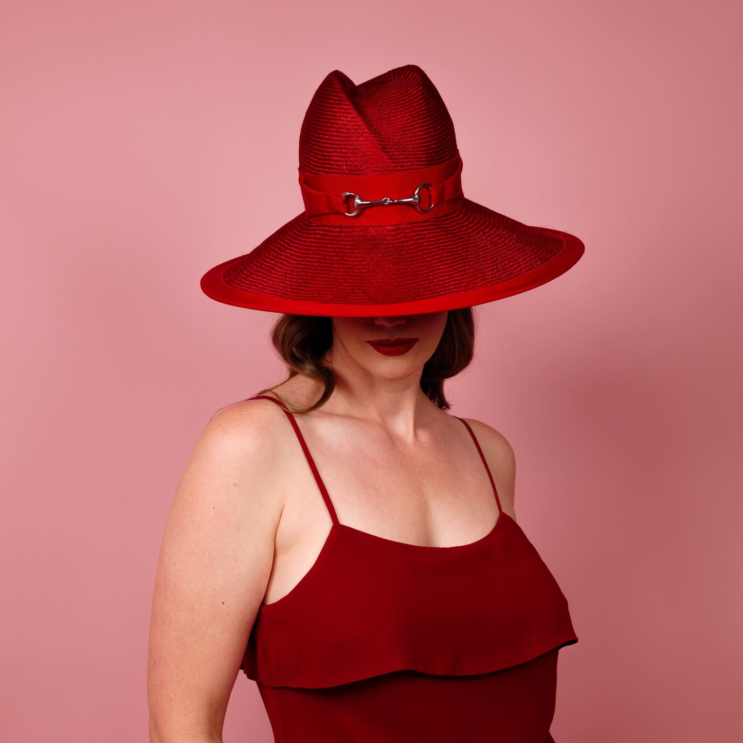 Charlotte wide brimmed hat with shaped crown in red straw and silver buckle