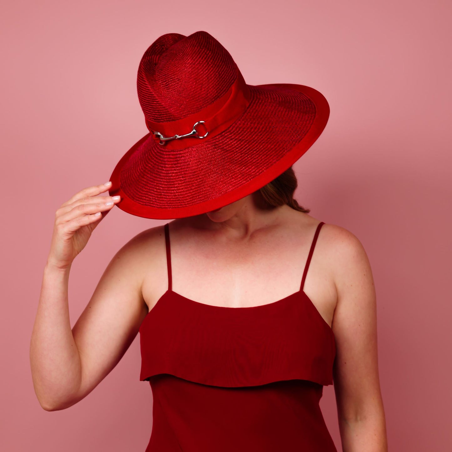 Charlotte wide brimmed hat with shaped crown in red straw and silver buckle