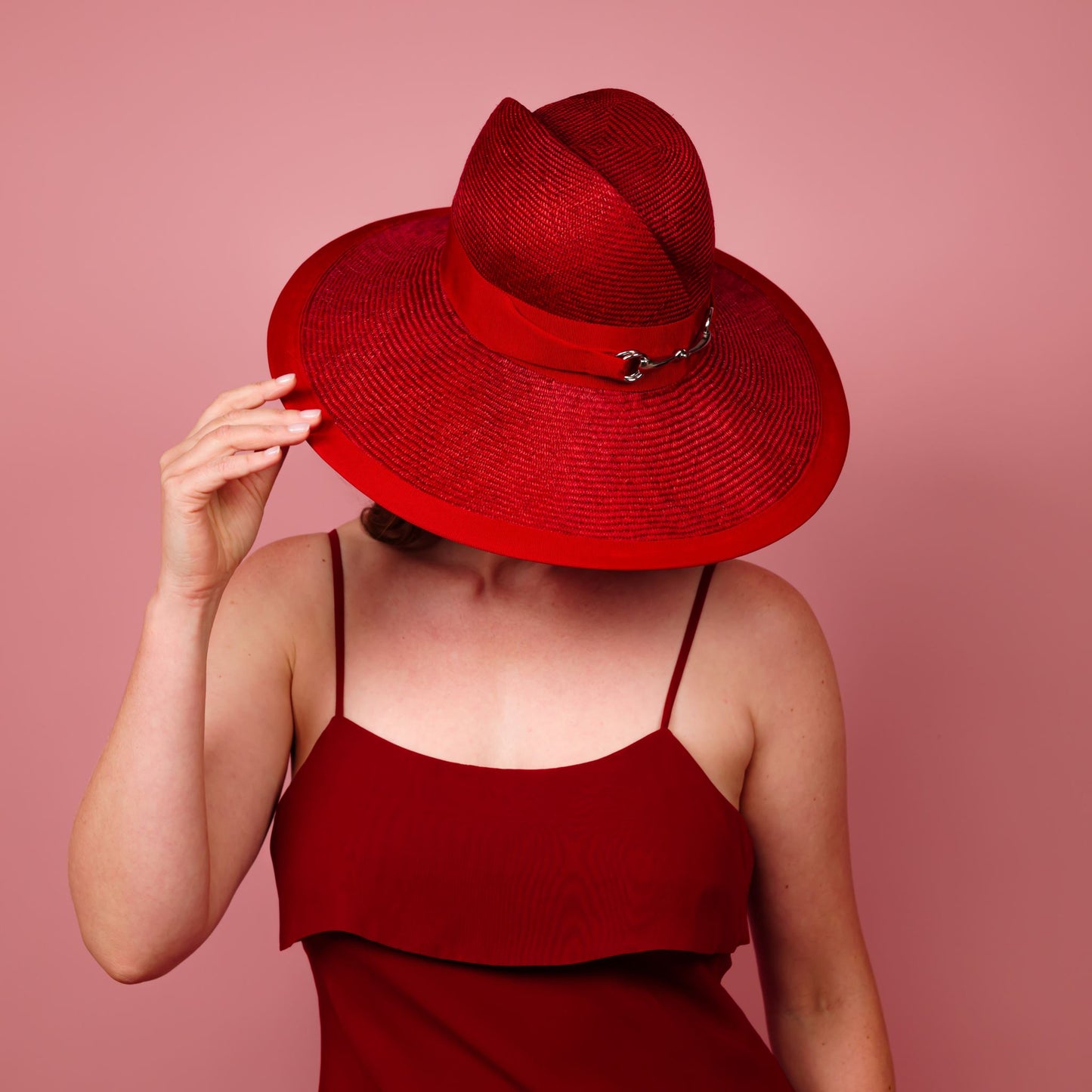 Charlotte wide brimmed hat with shaped crown in red straw and silver buckle