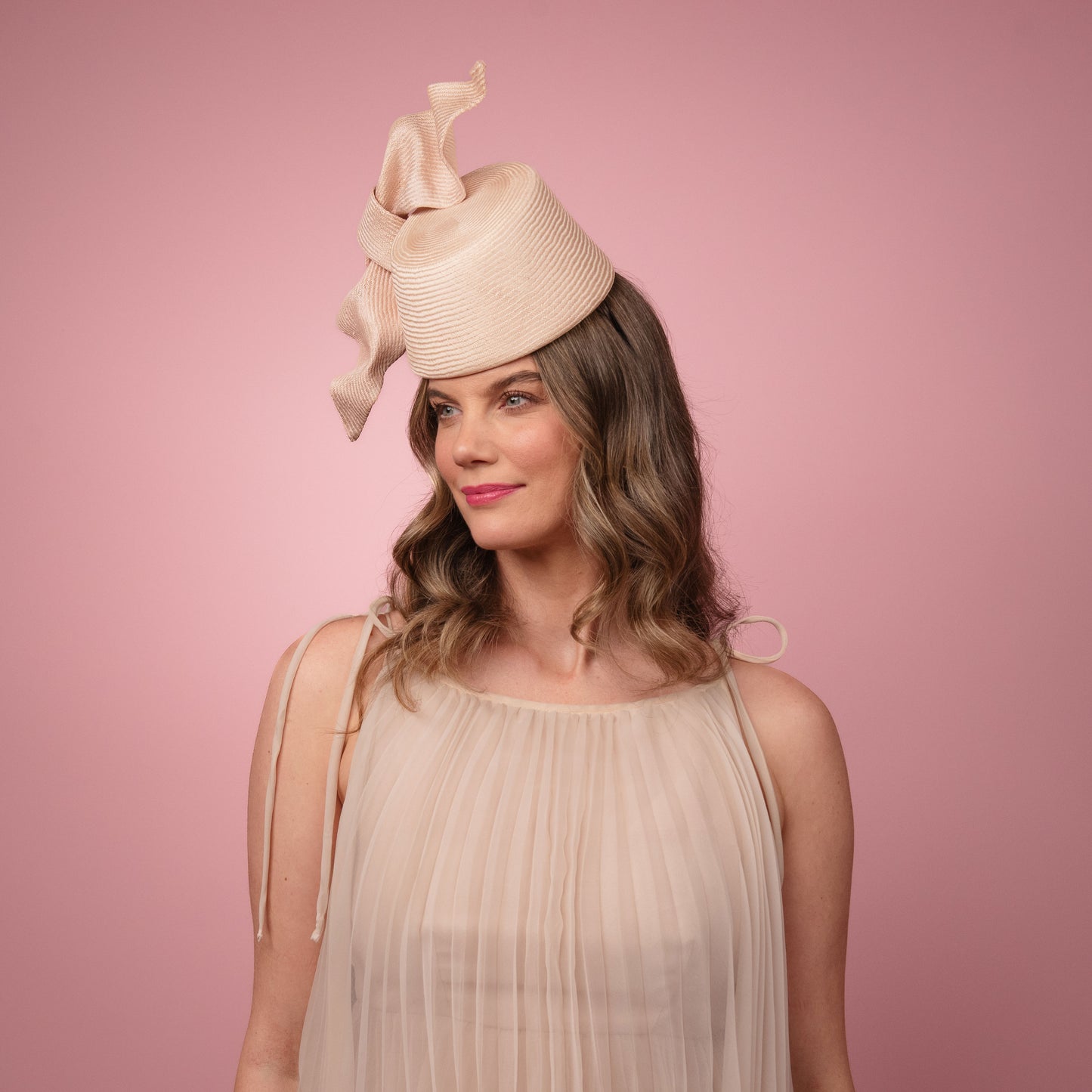 Cristina front of the head pillbox in pale pink with a knot trim Spring Racewear Headpiece