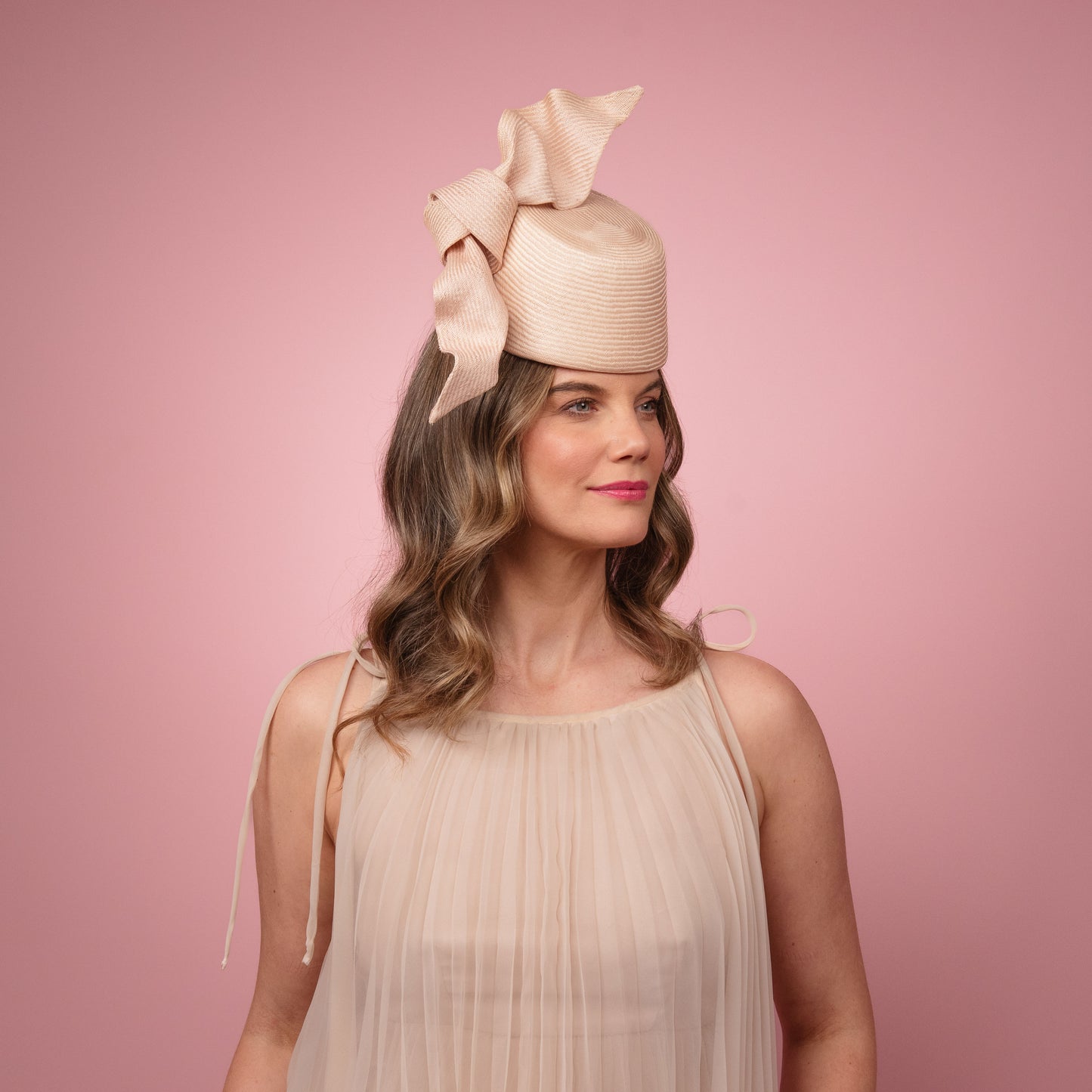 Cristina front of the head pillbox in pale pink with a knot trim Spring Racewear Headpiece