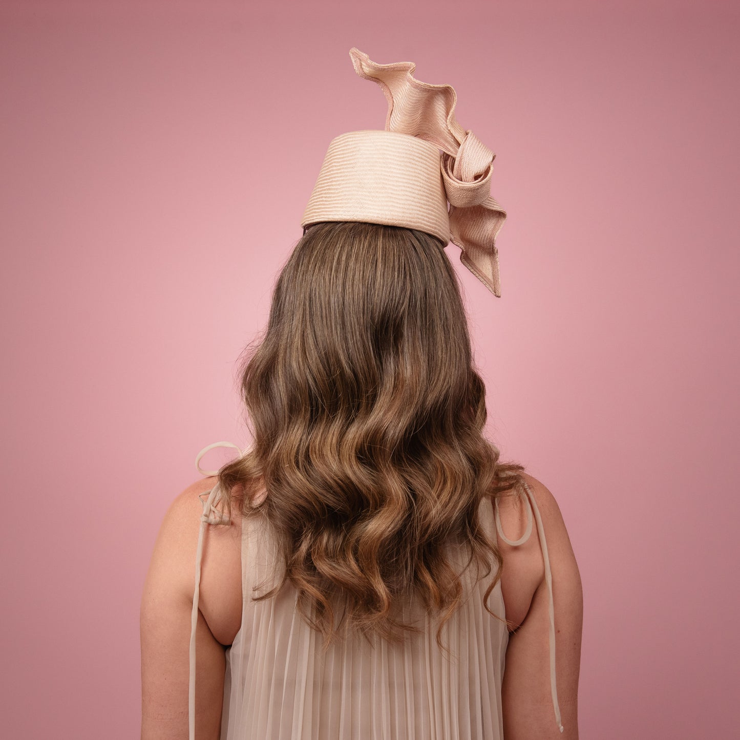 Cristina front of the head pillbox in pale pink with a knot trim Spring Racewear Headpiece