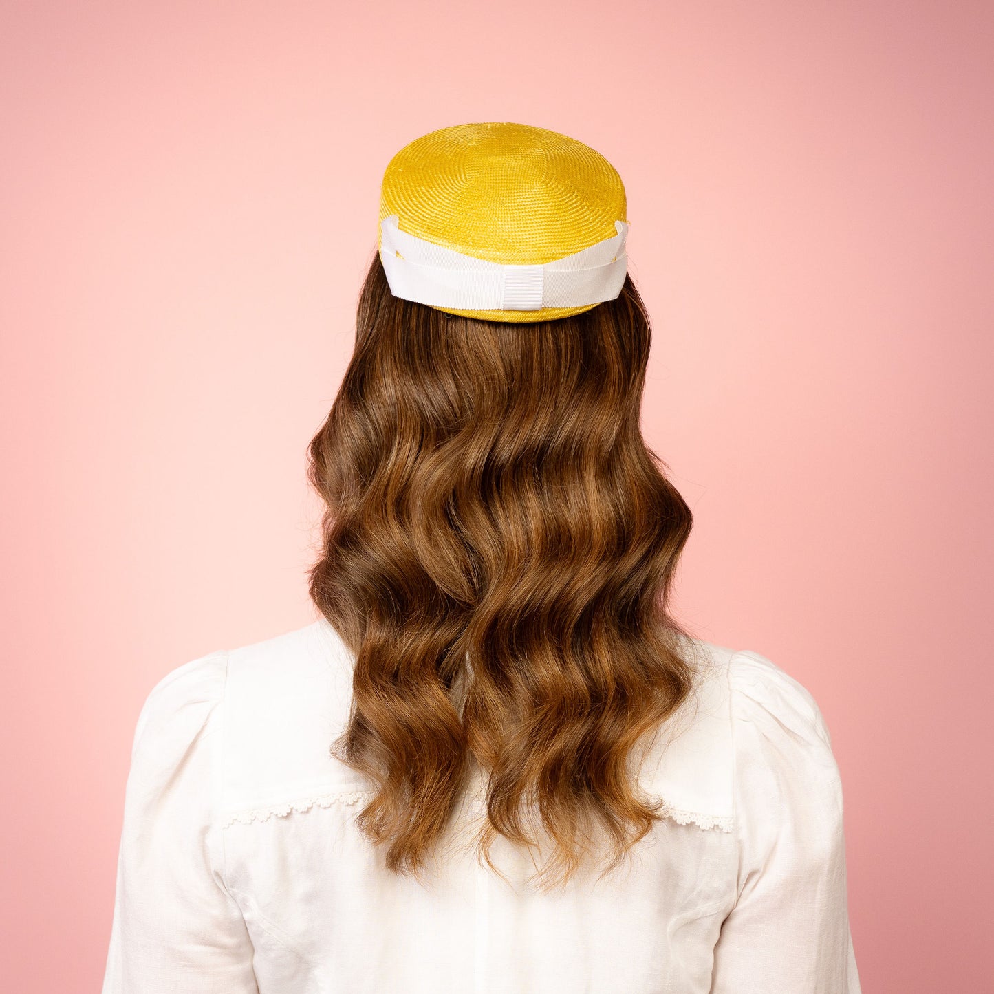 Peggy Pillbox in yellow straw with white petersham infinity bow Spring Racing Headpiece