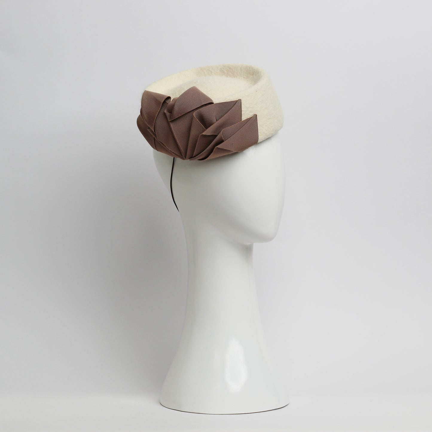 Fur felt Cream pillbox headpiece with pile trimmed taupe ribbon cockade by milliner Lauren J Ritchie 