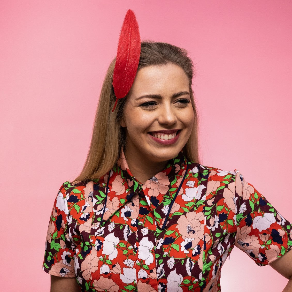 Picture of the Alba Headband in red, a floating tulle feather, secured to the head using a headband. Created by Melbourne based Lauren J Ritchie Millinery.