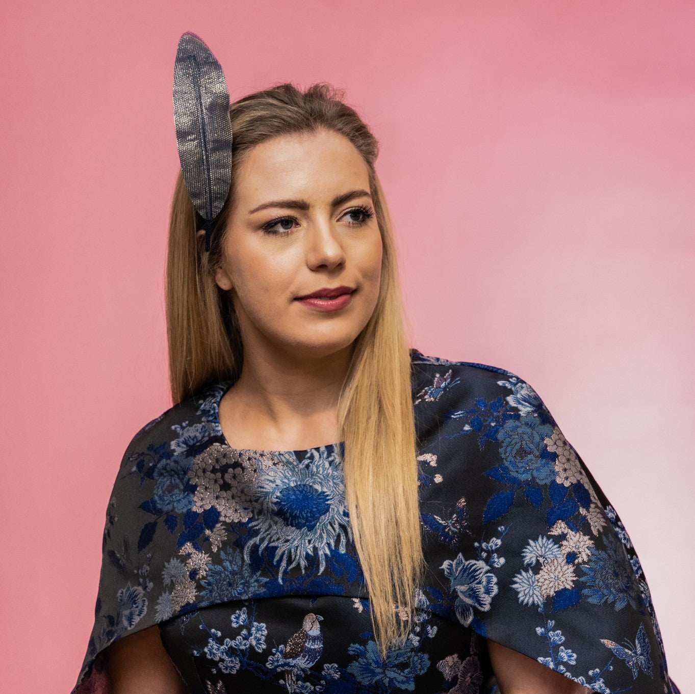 A picture of a model wearing the Alba Headband in navy, a floating tulle feather, secured to the head using a headband. Created by Melbourne based Lauren J Ritchie Millinery.