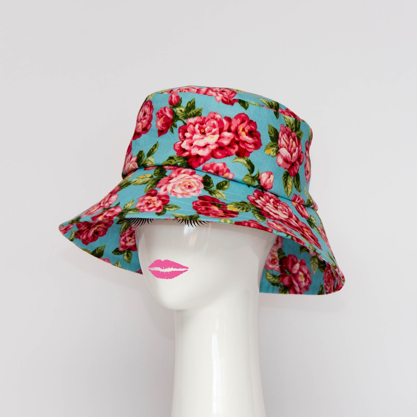 The Appin Bucket Hat in denim has a square shape crown with tip and side band.  The angle of the hat in the photograph shows the flared brim which protects you from the sun.  Created by Melbourne based Lauren J Ritchie Millinery.